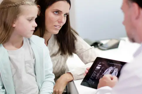 photo of doctor discussing diagnosis with mother