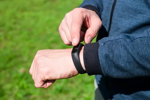 photo of man using step counter watch